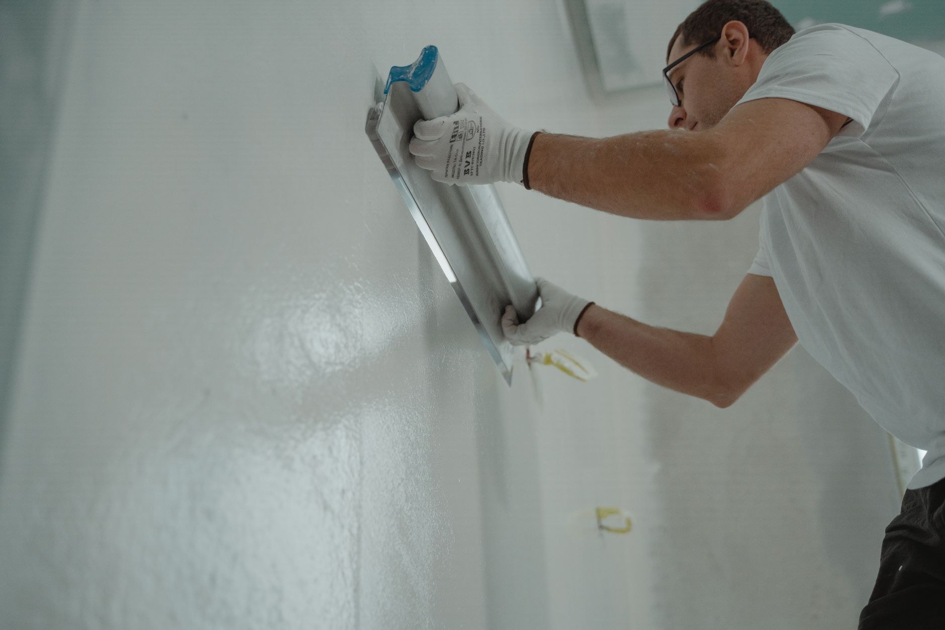 Plasterer skimming a wall to a paint-ready finish